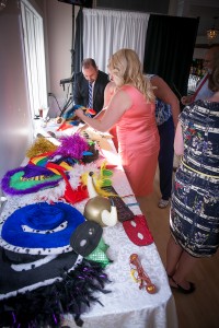 Photo booth with table holding lots of brightly colored props to be worn. Boston wedding DJ, JP, Photographer for Wedding Ceremony and Reception !