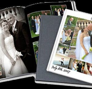 A couple is holding their wedding photos in an album.